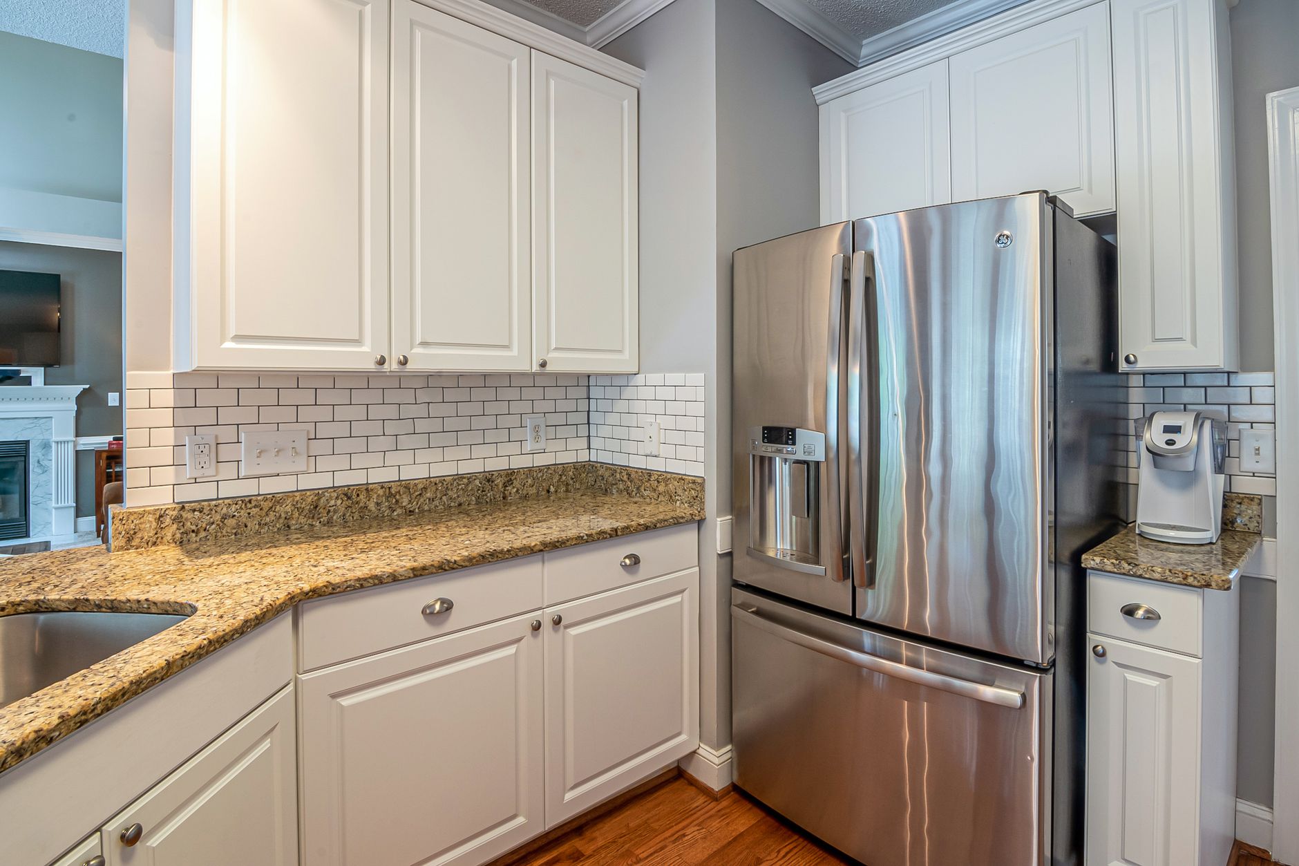 Bright modern kitchen with granite countertops, stainless steel appliances, and white cabinetry in Buncombe County, NC
